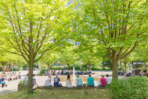 Students sitting by fountain on North Campus in summer.