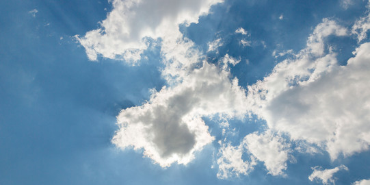 A blue sky with small white clouds.